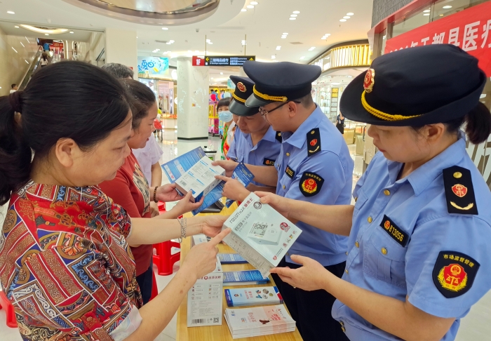 图为7月23日工作人员向群众宣传医疗器械使用方法及注意事项。